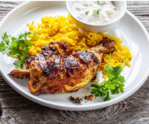 Juicy, char-grilled tandoori chicken with a smoky aroma, marinated in a spiced yogurt blend and served with fresh lemon wedges and mint chutney