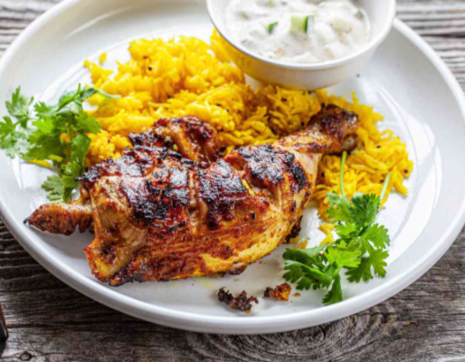 Juicy, char-grilled tandoori chicken with a smoky aroma, marinated in a spiced yogurt blend and served with fresh lemon wedges and mint chutney